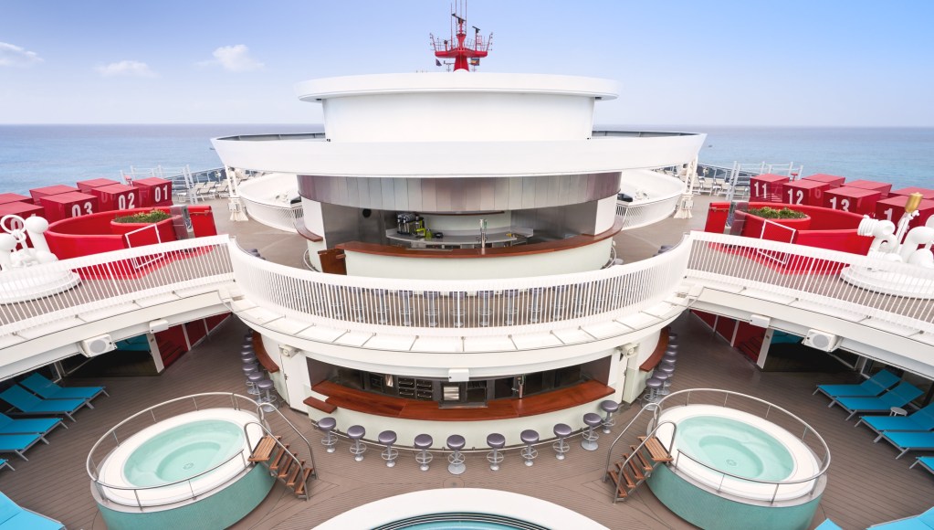 Virgin Voyages Scarlet Lady Gym and Tonic bar overlooking the Wellbeing Pool